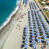 Italy, Cittadella del Capo beach, parasols